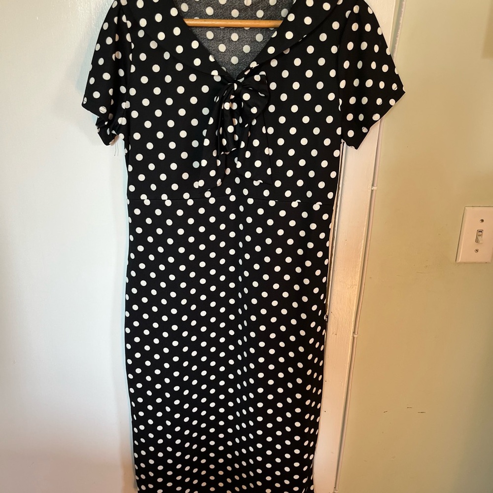 Vintage-style polka dot dress, white on black. L. Adorable floppy bow at neck.